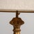Carved giltwood floor lamp in Antique Gold. The antique gold surface highlights ornate carved column, gilt finish,...