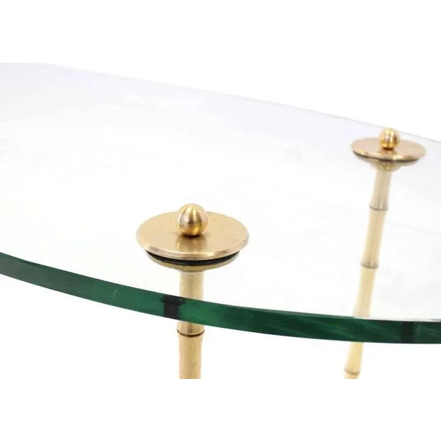 Nice brass and glass mid century modern oval coffee table. In style of Maison Bagues. Made in the early 20th century.