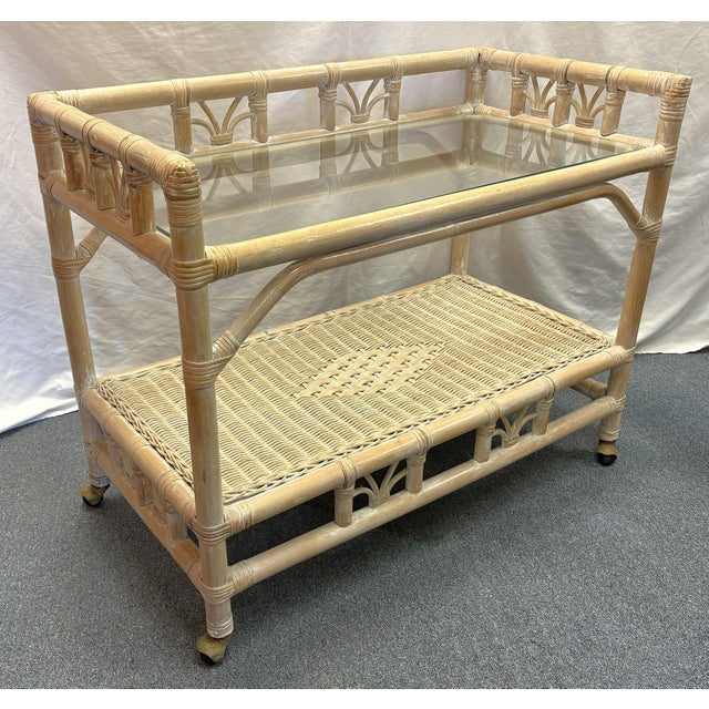 Versatile vintage Ficks Reed style rolling bar cart from the late 20th century. It's made of rattan in a driftwood color...