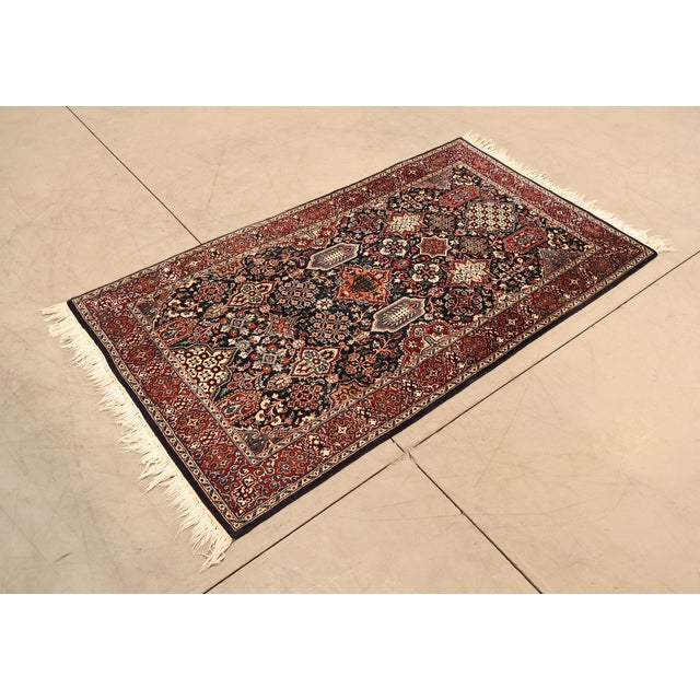 High Quality Persian Bakhtiari Style Rug Featuring A Navy Field With Geometric Floral Panels Surrounded By A Red Border....