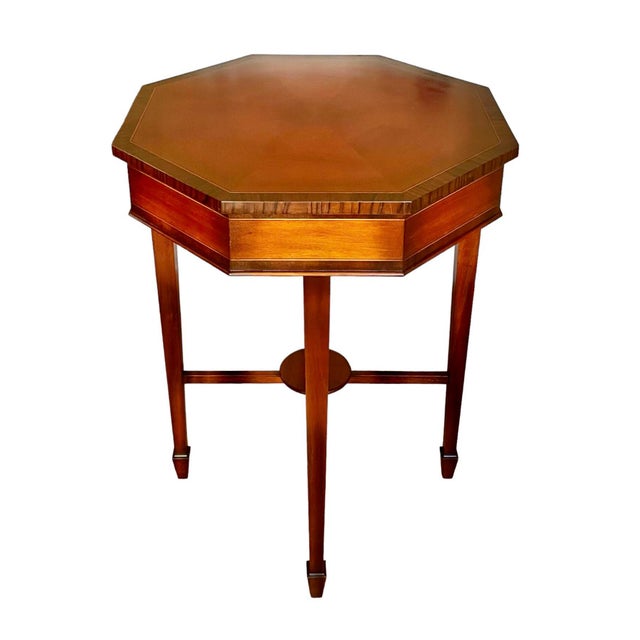 Mahogany solids coupled with crossbanded Roswood inlays accented by satinwood make this center table a striking piece....