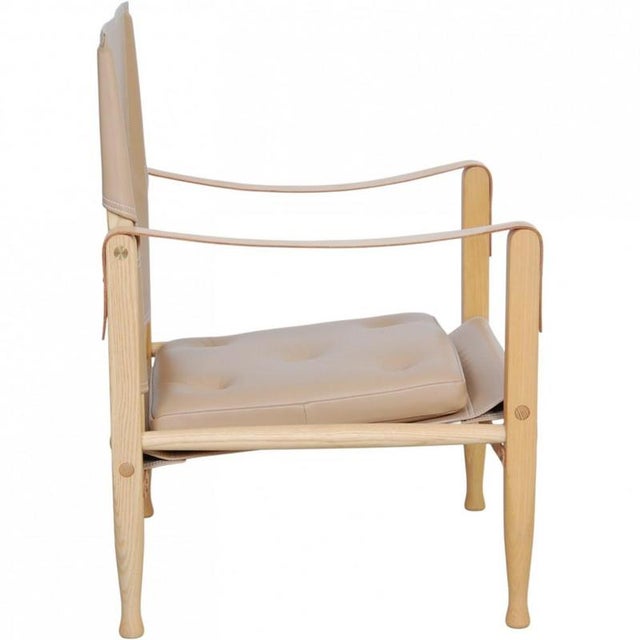 Kaare Klint Safari chair with a frame of ash and upholstery of natural leather. The chair is from 2018 and appears in...