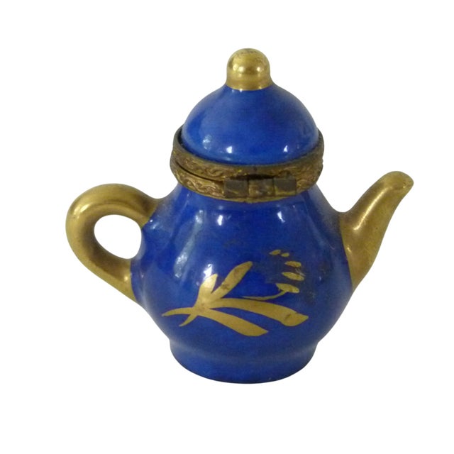 This tiny hand painted Limoges TEA POT trinket box has a rich Royal Blue glaze which is accented by bright Gold gilded...