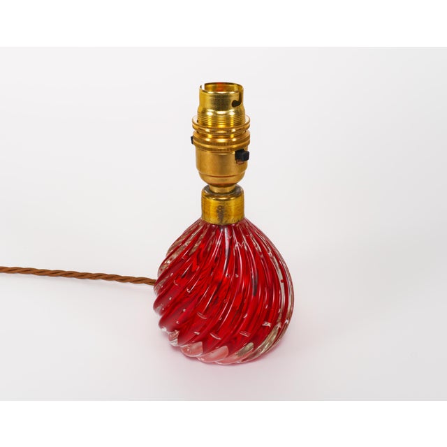 A scarce pair of small wrythen drop-shaped sommerso glass table lamps, with a core of ruby red, a layer of controlled...