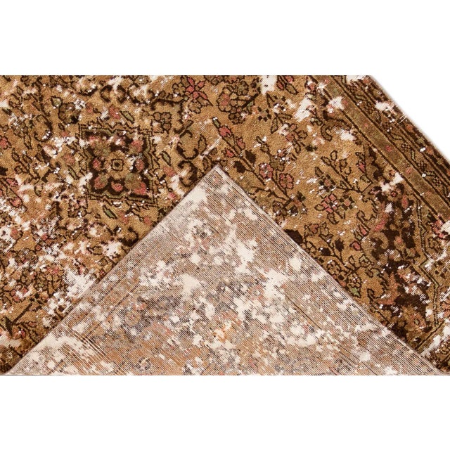 Beautiful vintage Distressed Turkish hand-knotted wool rug with a tan field. This piece has a pink and brown in an all-...