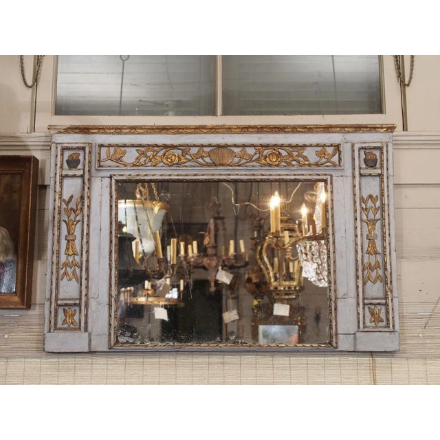 Early 19th century French Painted and gilded mirror with original glass. Painted a french blue color with gilded floral...