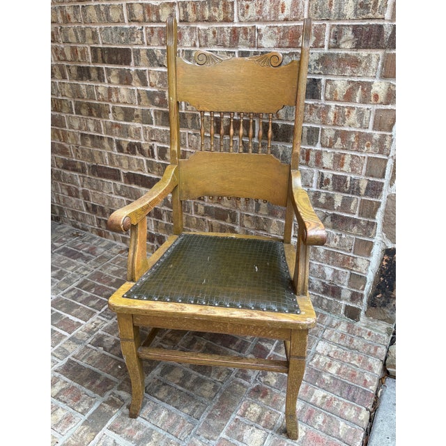 Rich with early 20th-century character, this substantial American oak armchair features beautifully aged quarter-sawn oak...