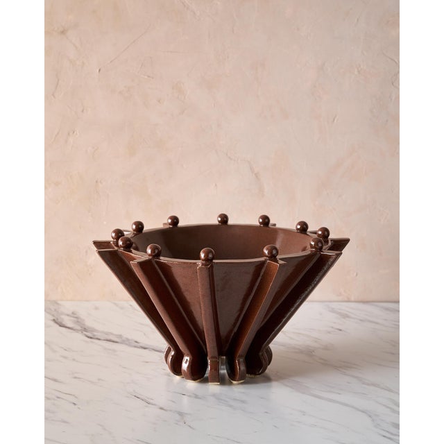 Designed as both a functional bowl and a statement art object for modern interiors, this gorgeous, sculptural stoneware...