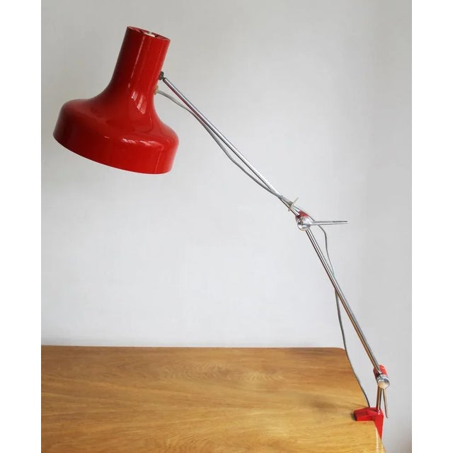 This bright red adjustable lamp was designed by Napako Lightning company in the 1960’s Czechoslovakia. It’s designer,...