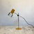 An Italian desk lamp by Prova. The cylindrical head is enamelled in mustard yellow and terminates in a wider, spun brushed...