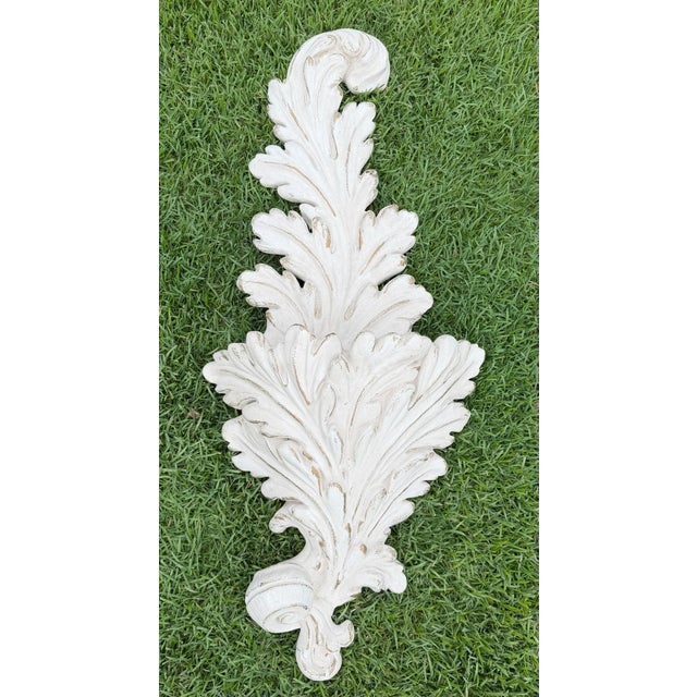 A substantial architectural wall planter featuring a classic acanthus leaf design with a distressed ivory finish and hand-...