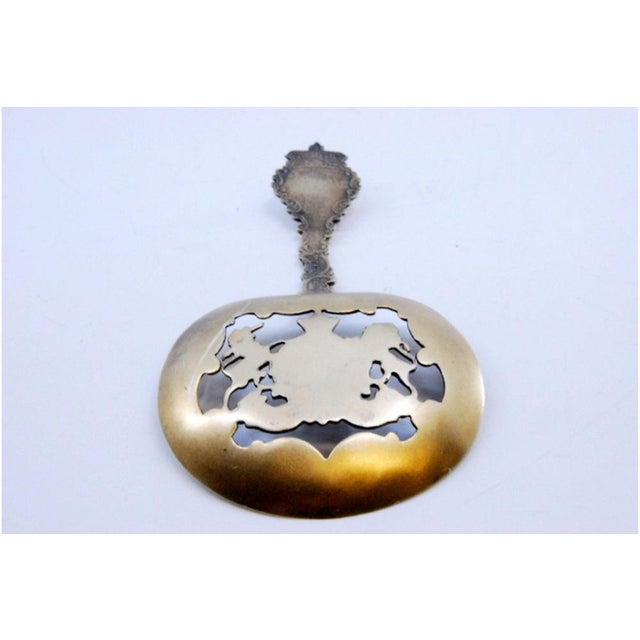 Silver Souvenir Spoon with Polychrome Cut-Out Shell, in Very Good conditions. Designed from 2000 This piece has an...