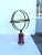 A brass armillary resting on a wonderful marbleized painted base. A classic with a modern twist