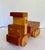 Here is a handcrafted wooden toy truck by Sam Sellers, showcasing the warmth and character of natural wood in a...
