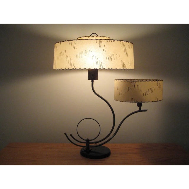 Machine age sculptural metal two shade table lamp. This lamp has a double brass curved sculptural form that holds two bulb...