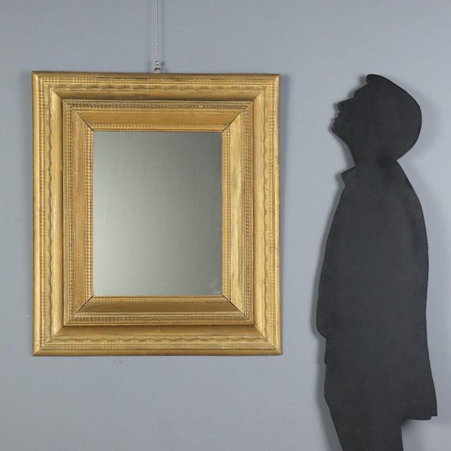 Giltwood mirror dating back to the late 19th century, originating from Italy. The frame features an exquisite guilloché...
