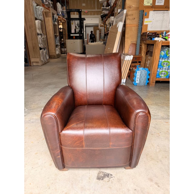 Add warmth and character to your space with this contemporary Western-inspired club chair. Upholstered in rich brown...