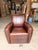 Add warmth and character to your space with this contemporary Western-inspired club chair. Upholstered in rich brown...