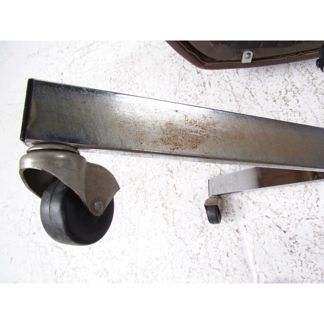 This high back desk chair features shapely vinyl swivel seat and sturdy metal base. Stylish Mid-Century Modern design adds...