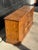 A classic vintage-style buffet or console showcasing warm wood veneer, decorative cane-style lattice door fronts, and...
