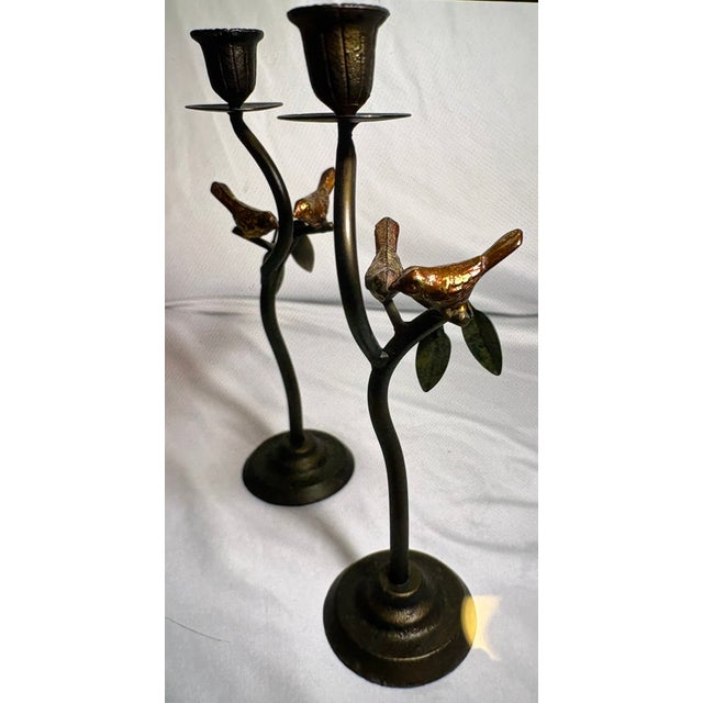 I have here a pair of cast iron candle stick holders from the 1980's styled after Curtis Jere, featuring birds on branches...
