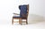 French lounge chair, produced in the 1950s. Crafted from solid oak with a high backrest, spindle arm supports, and wing-...