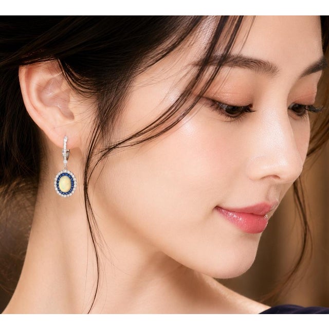 Elevate your collection with these stunning Art Deco-inspired dangle earrings, crafted in luxurious 18K white gold....