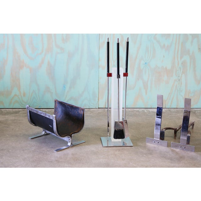 A complete set of fireplace tools designed by Alessandro Albrizzi. The set includes a pair of chrome andirons; a lucite...