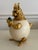 Large gilded over silverplate squirrel box. The body is an ostrich egg. He holds a malachite acorn. Fine detailing in the...
