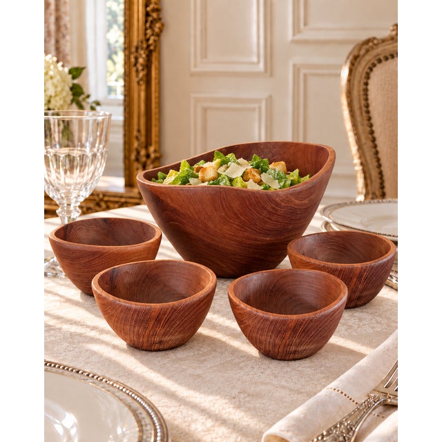The large bowl is distinguished by its organic asymmetrical form, dramatically rising rim and richly figured teak grain....