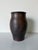 A beautiful 1977 vintage studio pottery vase featuring an organic hand-thrown form and rich earthy glaze tones. This...