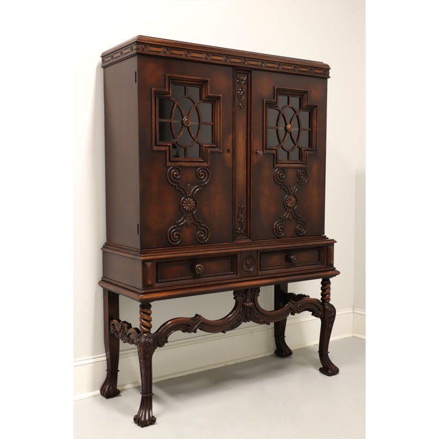 An antique French Gothic style china display cabinet by Rockford Chair & Furniture Co. Walnut with decorative cornice to...