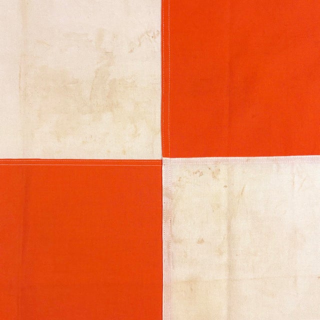 This vintage airfield safety flag is made from a cotton cloth in vibrant orange and yellowed off-white, with fully sewn...