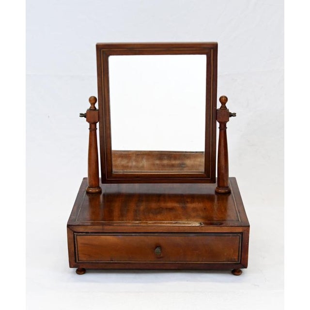 An elegant Georgian mahogany dressing mirror with fine contrasting inlaid stringing The rectangular mirror sits between...