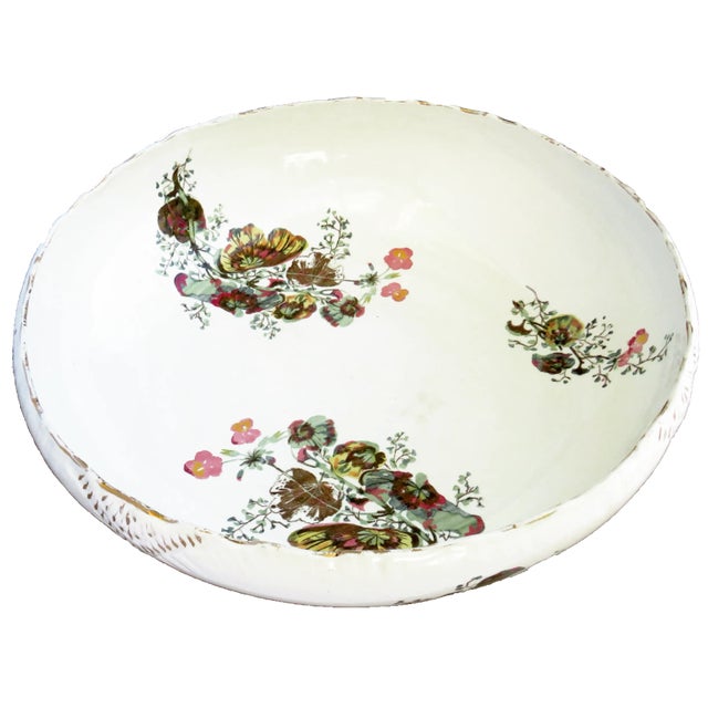 Generously proportioned, antique English earthenware bowl with white field adorned by gilt and floral accents. Perfect for...