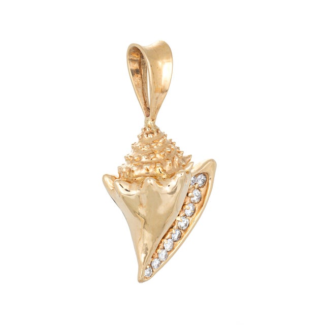 Finely detailed vintage conch shell pendant crafted in 14k yellow gold (circa 1970s). The beautifully detailed large...