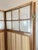 Elegant antique four-panel screen in carved wood, with glass panels in the upper section and panels upholstered in striped...
