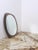 The shape is essential and refined, a beveled oval mirror superimposed and contained by a rose bronze colored glass frame,...