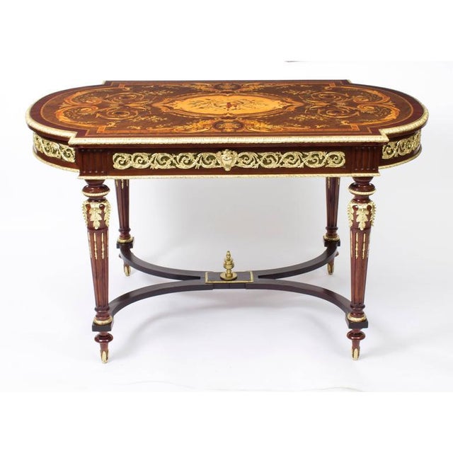 This is a fabulous French antique ormolu mounted bureau plat which features fine quality floral marquetry and which dates...
