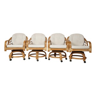 Set of Four Vintage Coastal Rattan Swivel Lounge Chairs on Casters With Original Cushions For Sale