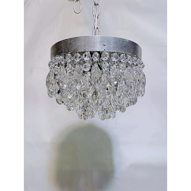 Bring a sleek, retro-modern edge to your home with this stunning vintage mid-century chrome crystal chandelier. Stepping...