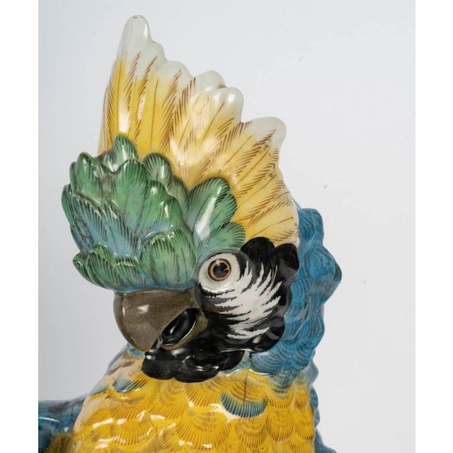 A 19th century sculpture of a parrot, napoleon iii period, in paris porcelain. H: 50cm, w: 30cm, d: 18cm