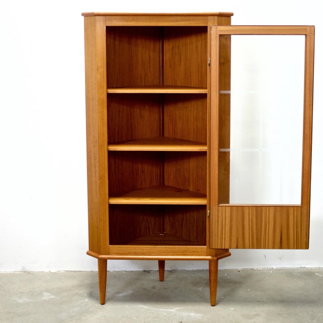 Dimensions: 28 1/2” L x 20 1/4” D (wall side) x 56 3/4” H / 17 1/2” D door to corner Origin: Denmark Designer: Unknown...