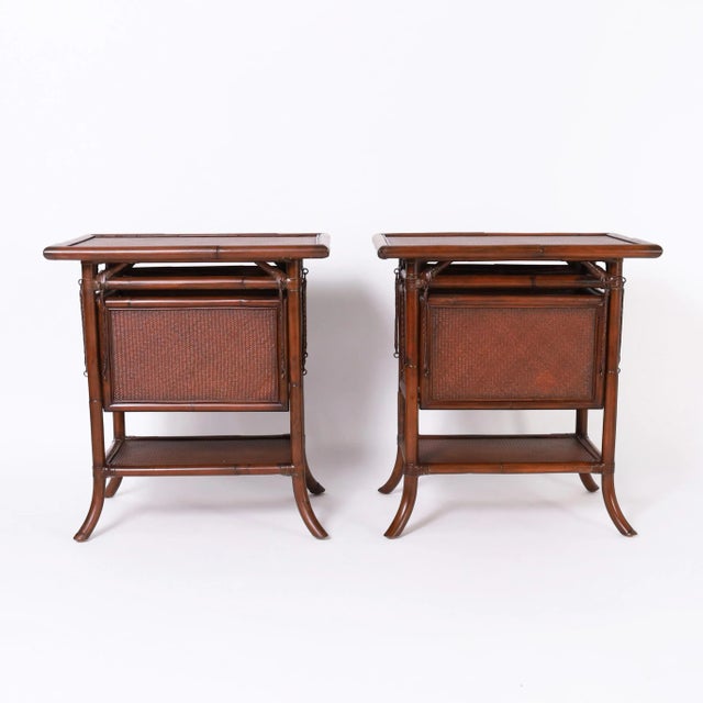 Impressive pair of mid century stands crafted in grasscloth and bamboo with four transforming foldout trays or surfaces,...