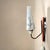 A vintage mid-century wall sconce featuring a stunning cone shaped opaline glass lampshade, painted white metal support,...
