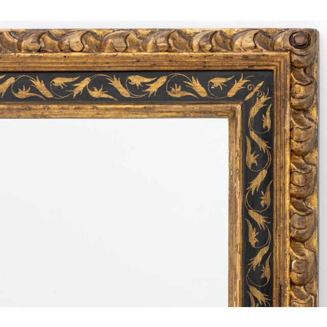 Italian Ebonized and Giltwood Framed Rectangular Mirror. Mirror: 46.75" H x 64" W; frame: 54" H x 72" W x 1.5" D....