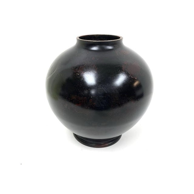 A cast metal Vase in traditional Japanese form having five gathered Koi in raised design. The Vase is finished in a fine...