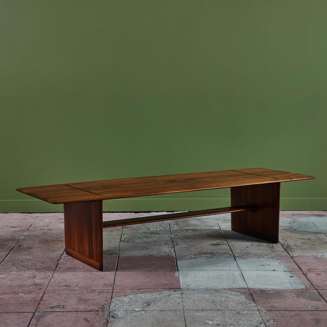 Brown Saltman rectangular coffee table, c.1950s, USA. The table features a knife edge walnut table top with beautiful...