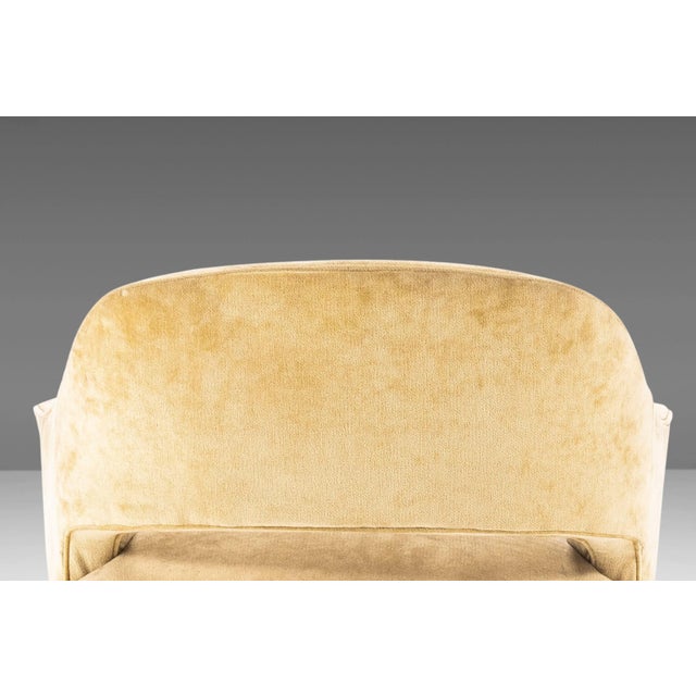 Mid-Century Modern low slung club chairs attributed to Harvey Probber. Chairs feature sculpted walnut legs with a curved...