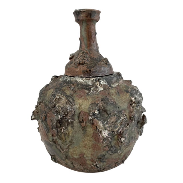 This Brutalist Studio ceramic urn with lid is handmade in the United States with a Japanese cultural influence. The green...